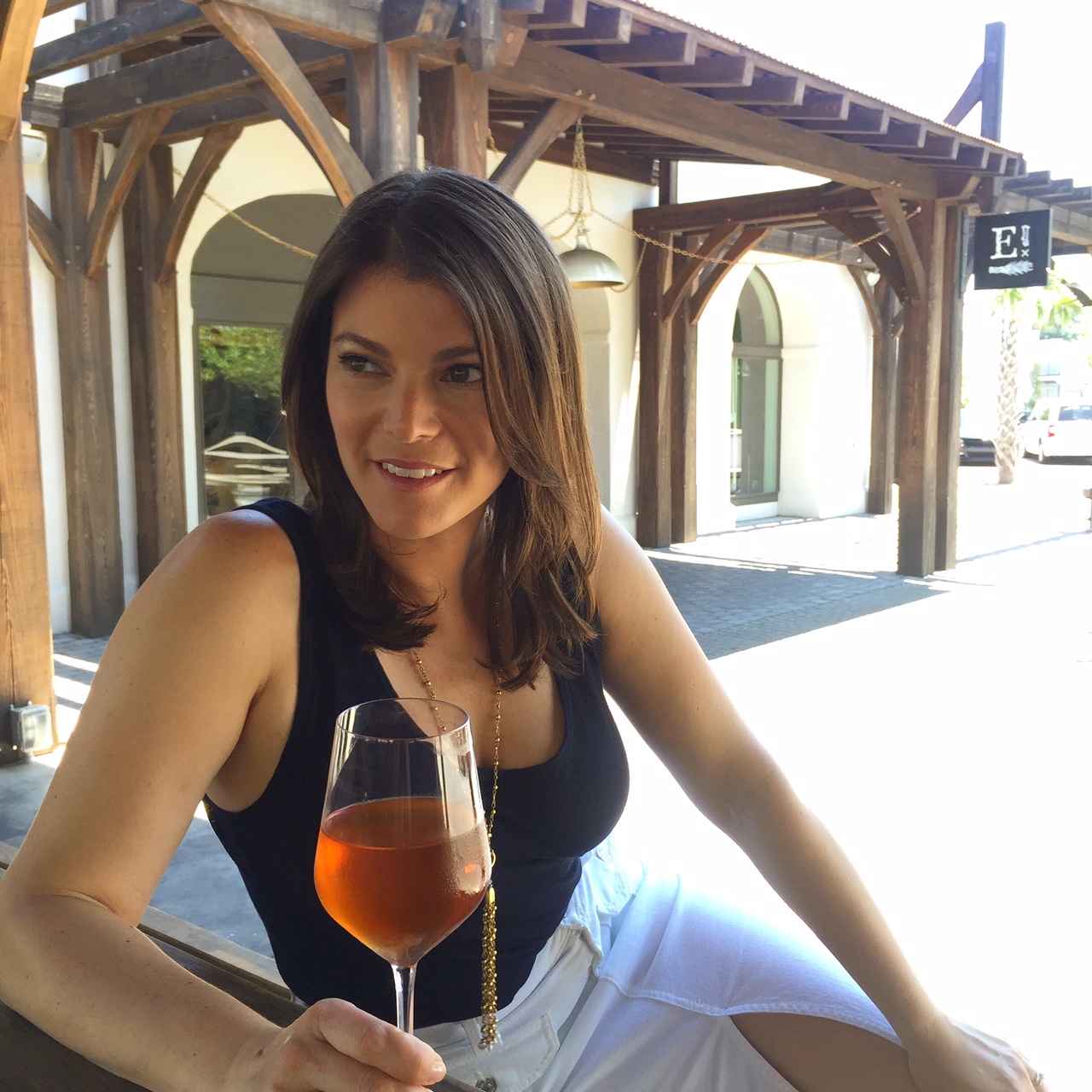 gail simmons from top chef holds glass of wine